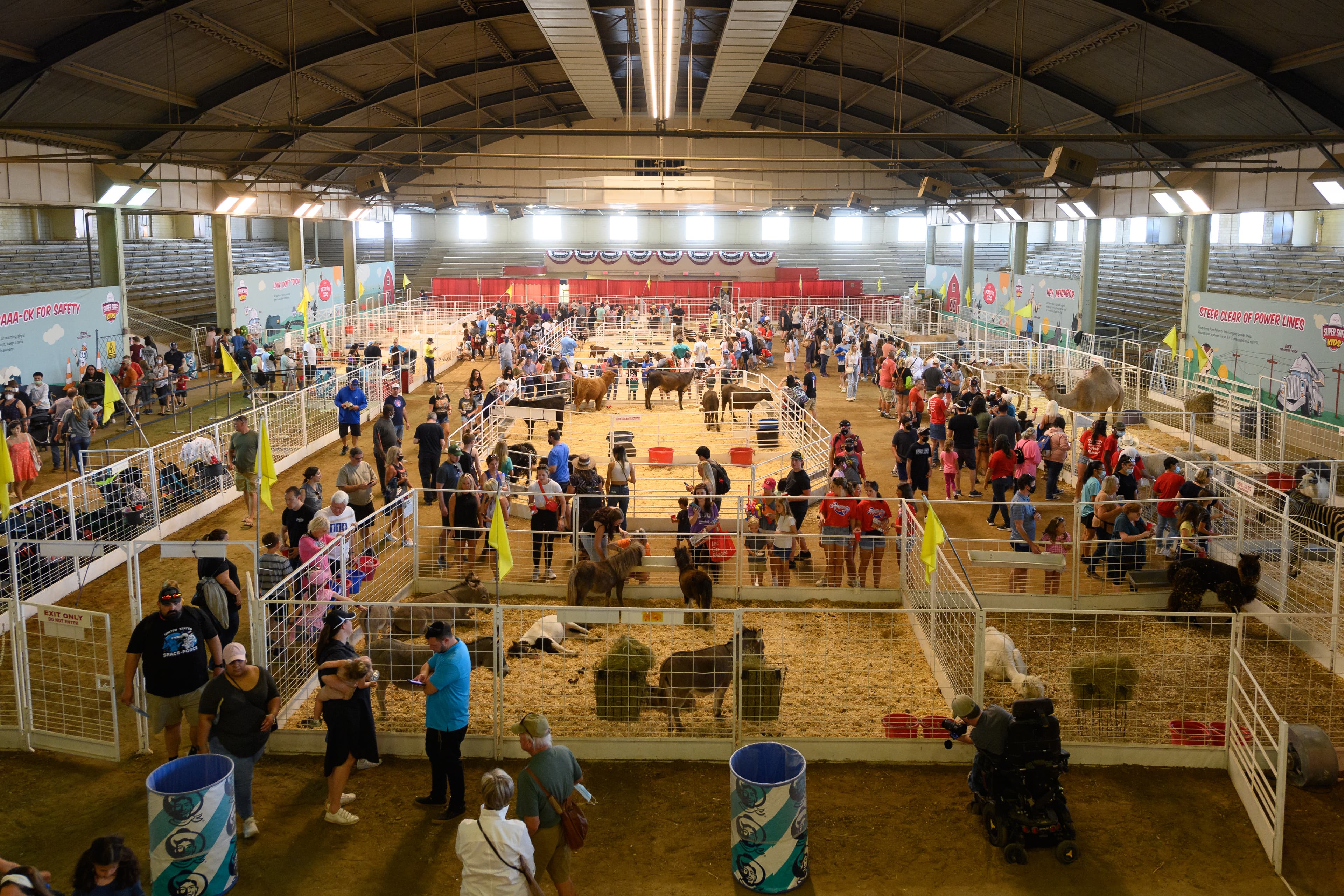 File photo: Visitors walk among indoor animal pens in 2021; this image does not show the petting zoo's new 2026 location.